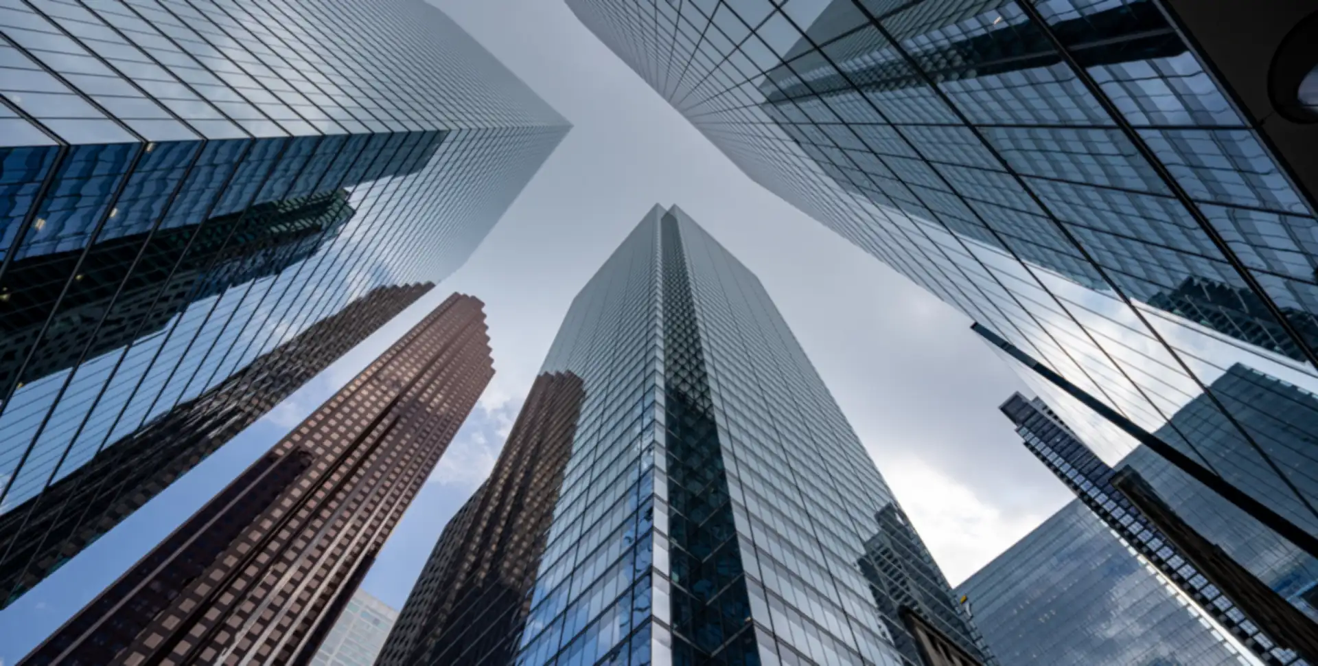 Looking up at glass skyscrapers in a commercial business district
