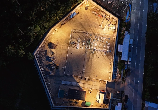 Night-time aerial view of the 69 kV capacitor bank station site during construction