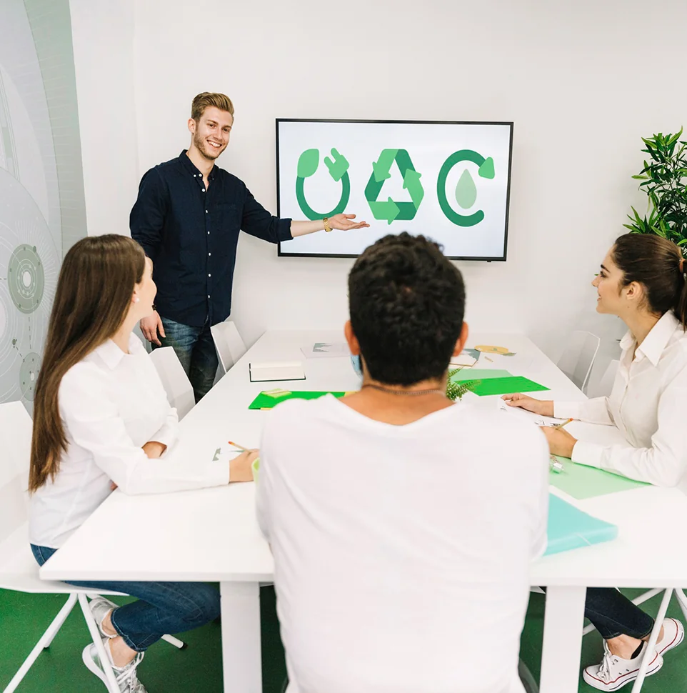 Team discussing a recycling and sustainability project around a meeting table