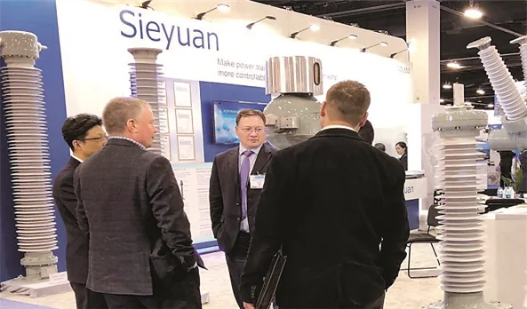Visitors talking with Sieyuan staff at the Sieyuan booth at the IEEE PES T&D exhibition