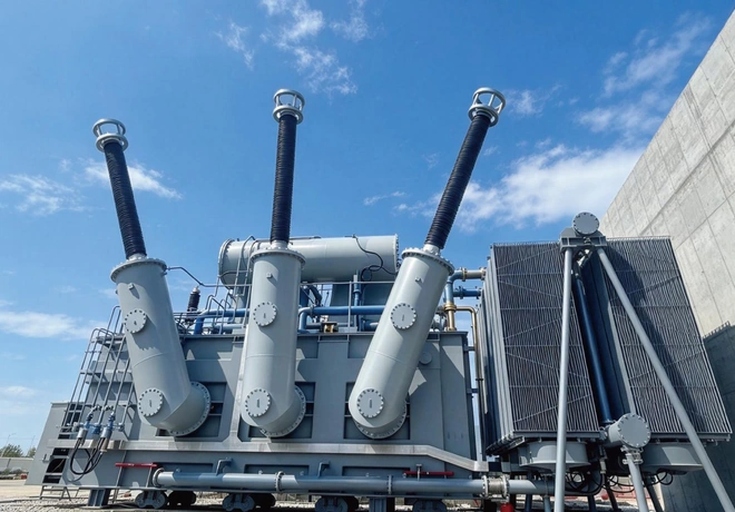 Three 400 kV bushings and radiator bank on the split-winding step-up transformer