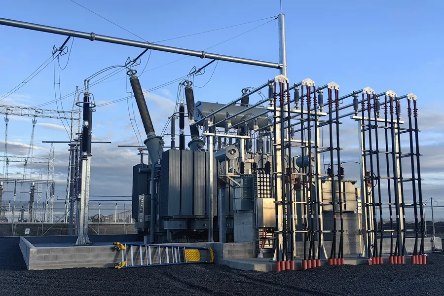 Fixed power transformer installed outdoors in a substation with overhead line connections