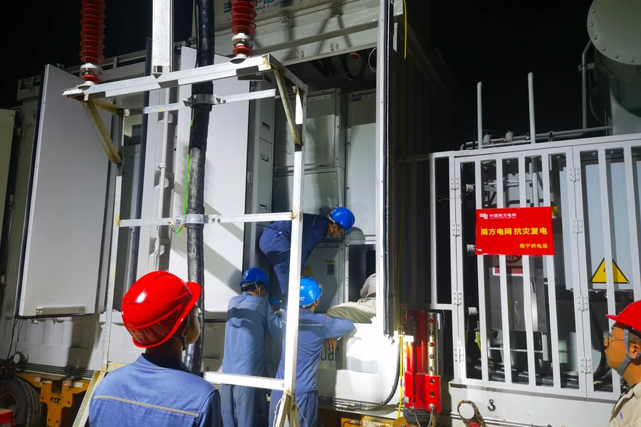 Engineers in hard hats working on a mobile substation during emergency power restoration
